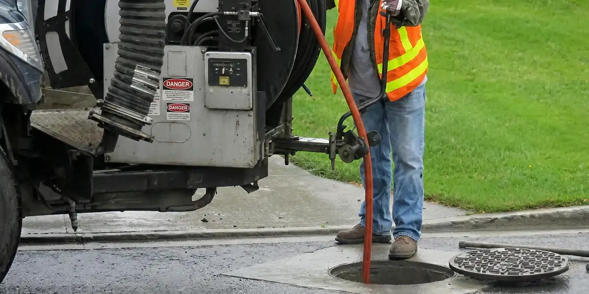 sewage clean up professionals using industrial equipment to remove contaminated wastewater in St Paul, MN