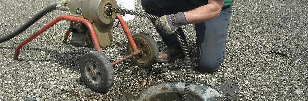 sewer rodding technician actively removing blockages from a sewer line in St Paul, MN