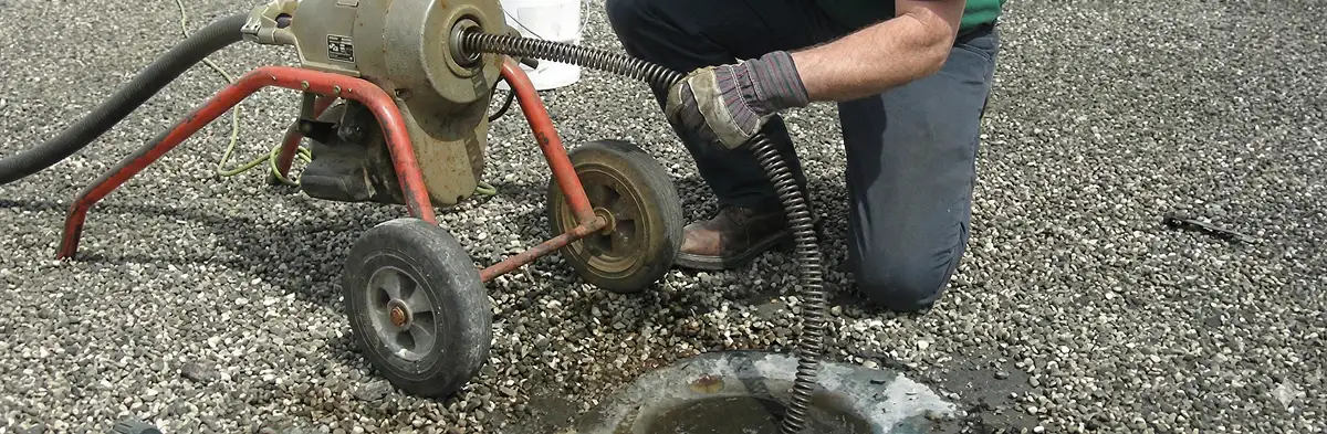 sewer rodding technician actively removing blockages from a sewer line in St Paul, MN